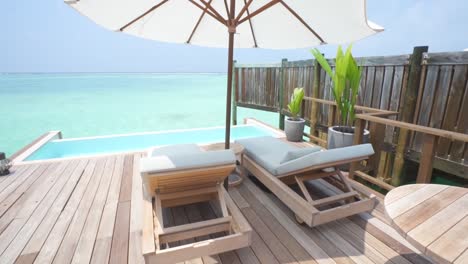 walking out to deck of overwater bungalow in maldives luxury resort