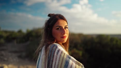 Slow-motion-bokeh-shot-of-a-model-watching-the-sunset-on-a-hillside