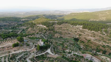 Aerial-view-Moving-Forward-Shot,-Scenic-view-of-Landscape-in-Sierra-Espuna-National-Park-in-Spain,-Sunny-blue-sky-in-the-background