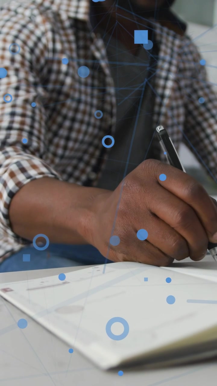 Vertical video: Man switching from pen to keyboard, typing while blue UI overlaying for tech