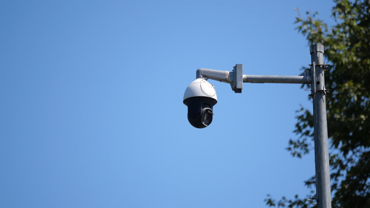 Security Camera on a Pole Against Blue Sky