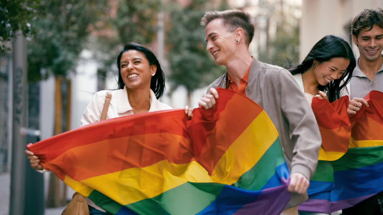 People celebrating LGBTQ pride with rainbow flag