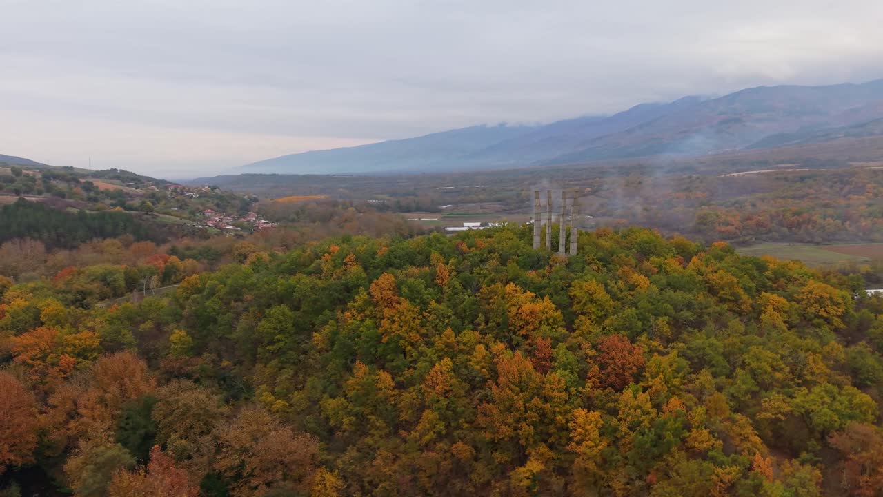 Aerial panoramic drone shot of Samuil's Fortress perched on a hill, surrounded by trees and natural landscape, showcasing the monument in its scenic environment