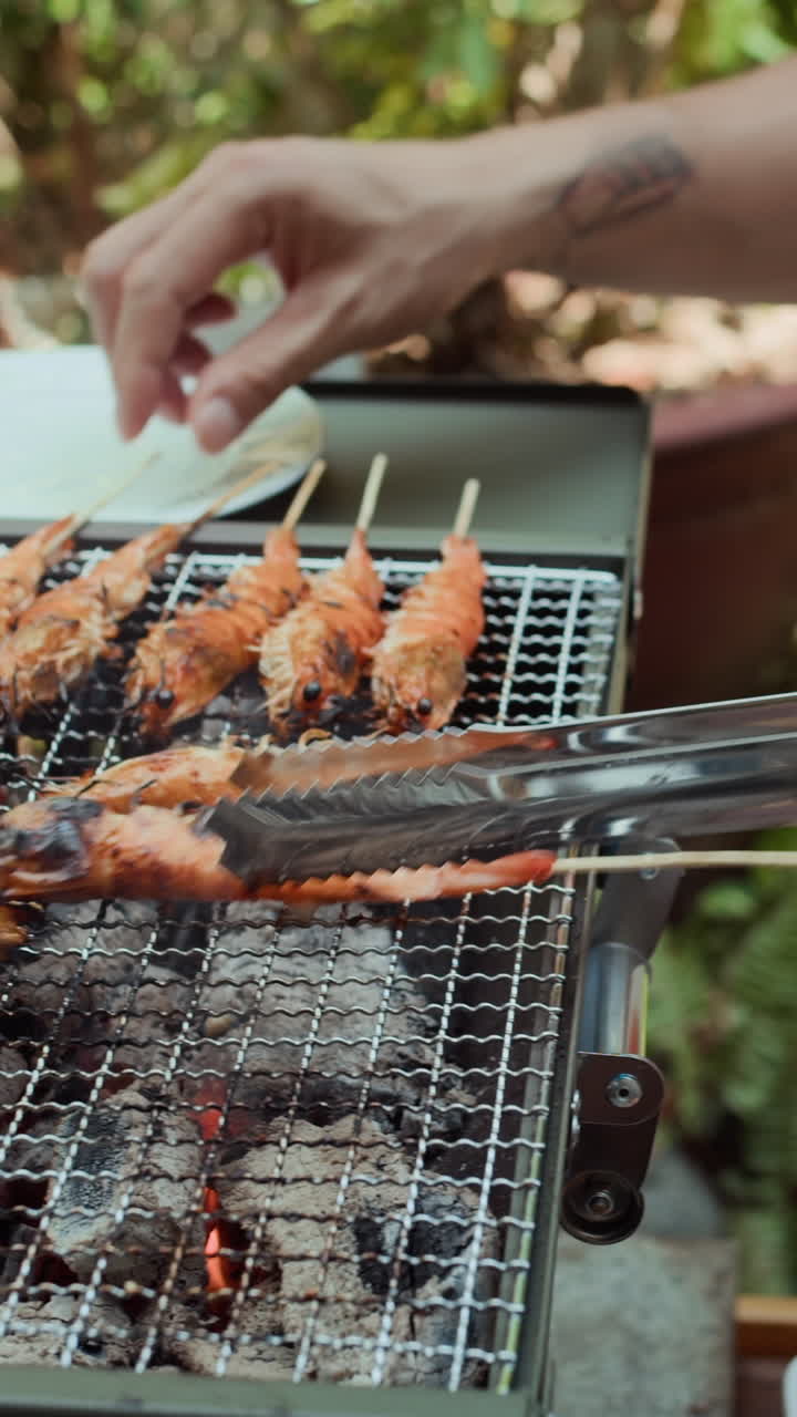 Hands of Man Checking Shrimps when Cooking on Grill