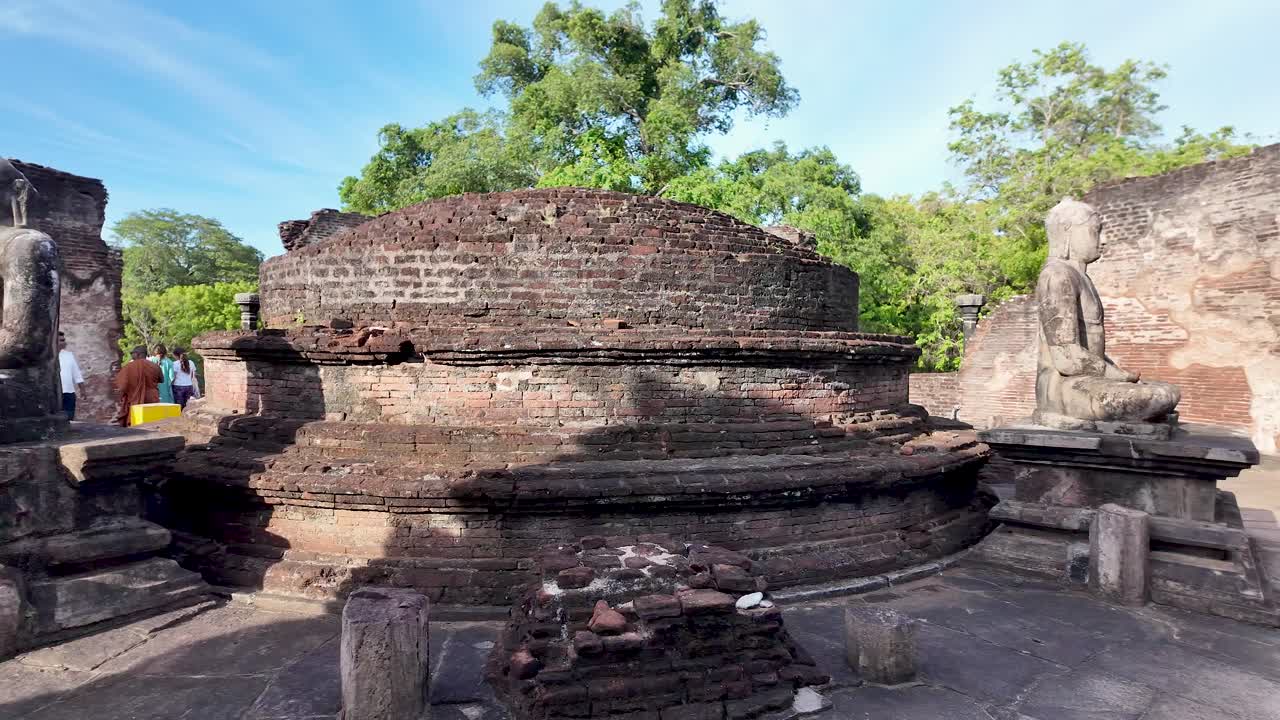 Buddha statues inside Polonnaruwa Vatadage, showcasing ancient architecture from the Kingdom of Polonnaruwa in Sri Lanka. Slow Motion, Pan Right