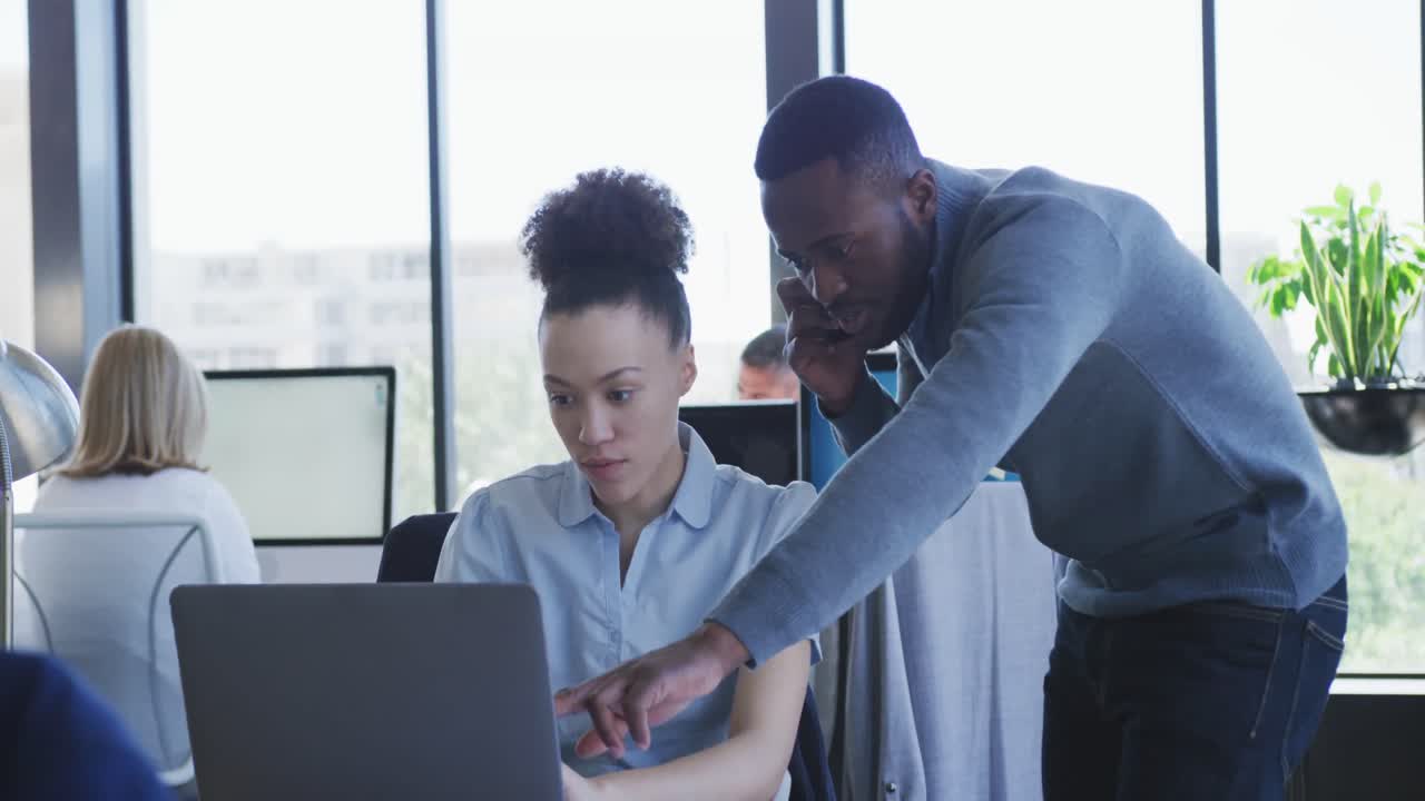 Young man and woman working on computer