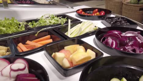 panning camera over the salad shelf stall in supermarket with many kind of fresh vegetable on stall