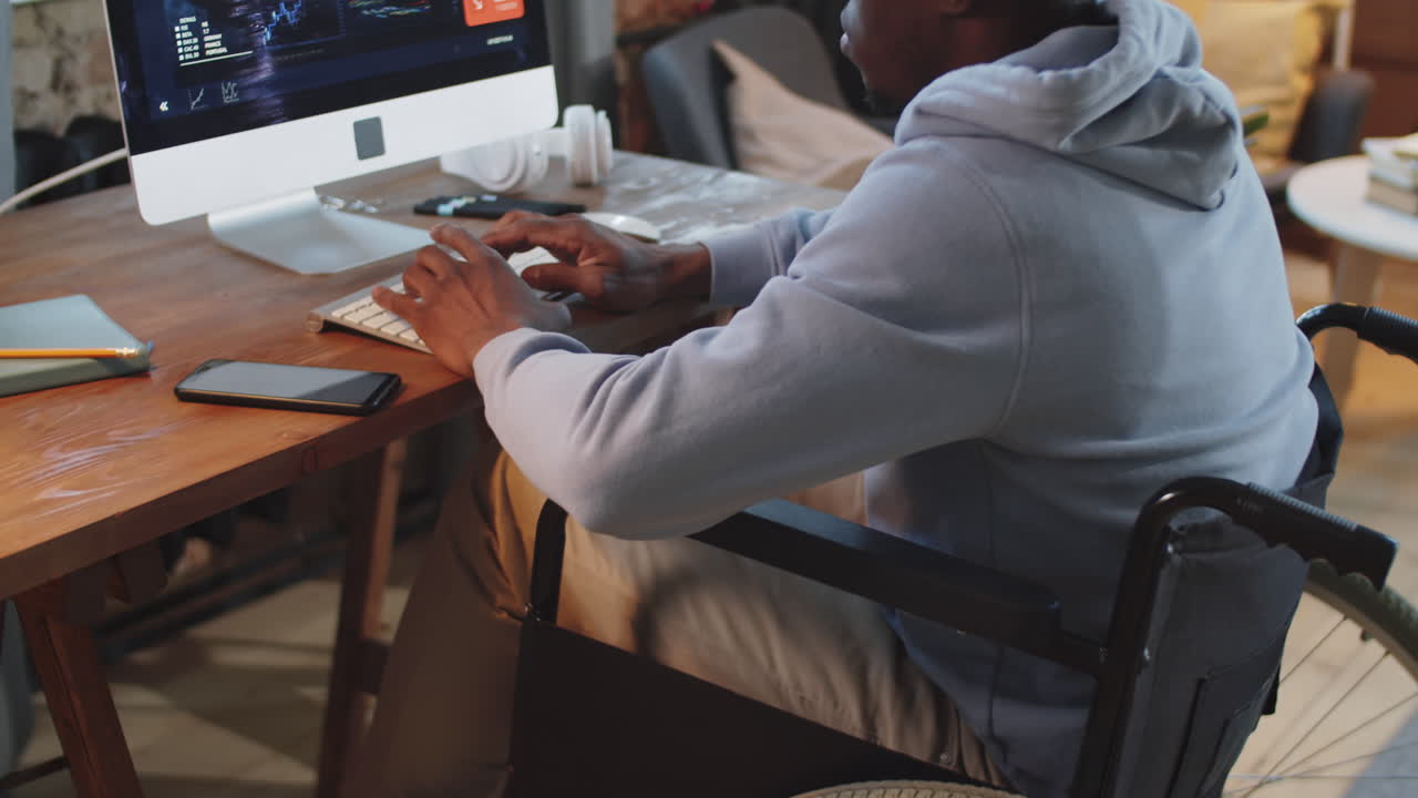 Man in Wheelchair Working on a Computer