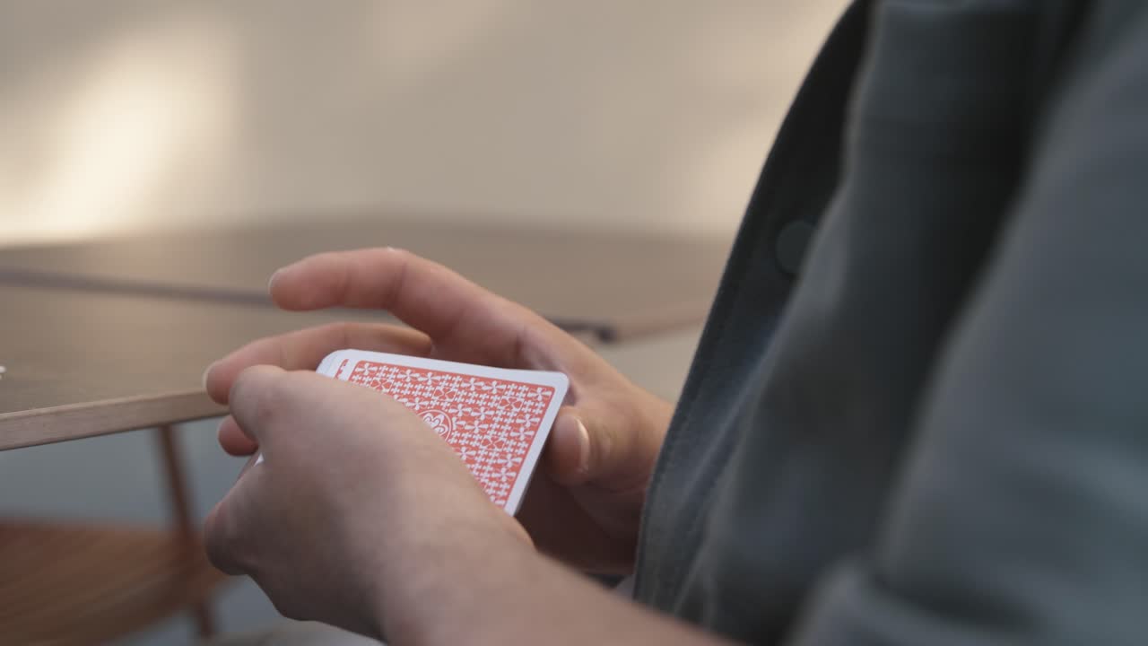 Close-up of a person shuffling a deck of playing cards