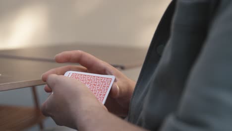 close-up of a person shuffling a deck of playing cards