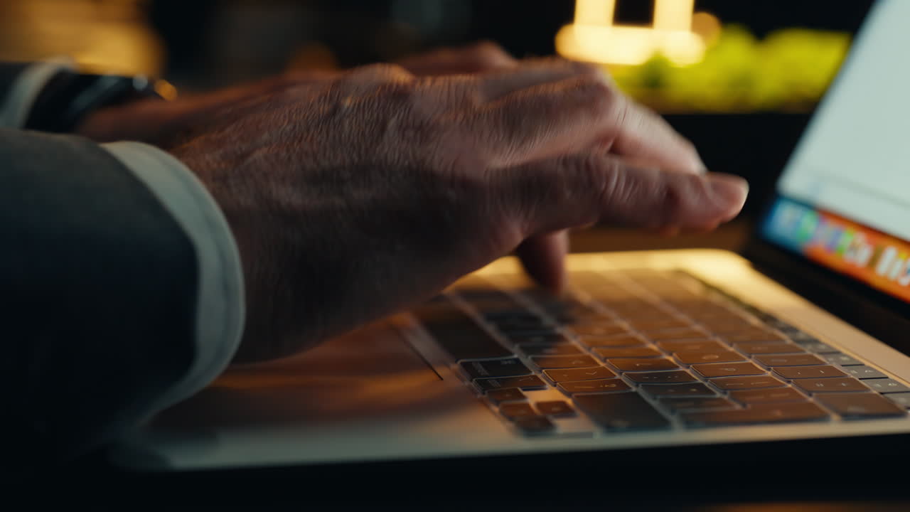 Hands typing keyboard night closeup. Late businessman working computer dark room