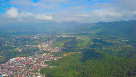 beautiful view of a sunny day in coban mountain's. the city is in the middle of the big green forest.