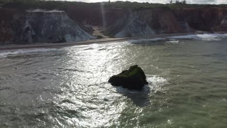 tambaba beach drone flying over surf spot with cliffside beaches and lone oceanic rocks