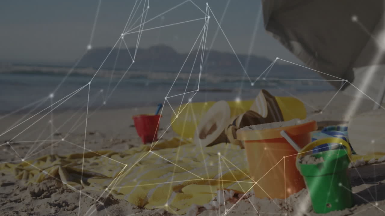 Beach toys and towel on sand with network connections animation overlay