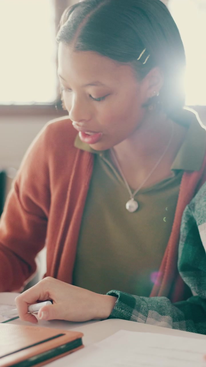 Young Woman Studying with Friend at a Table