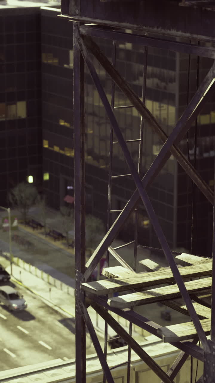 Urban landscape showing industrial structure and city street at sunset