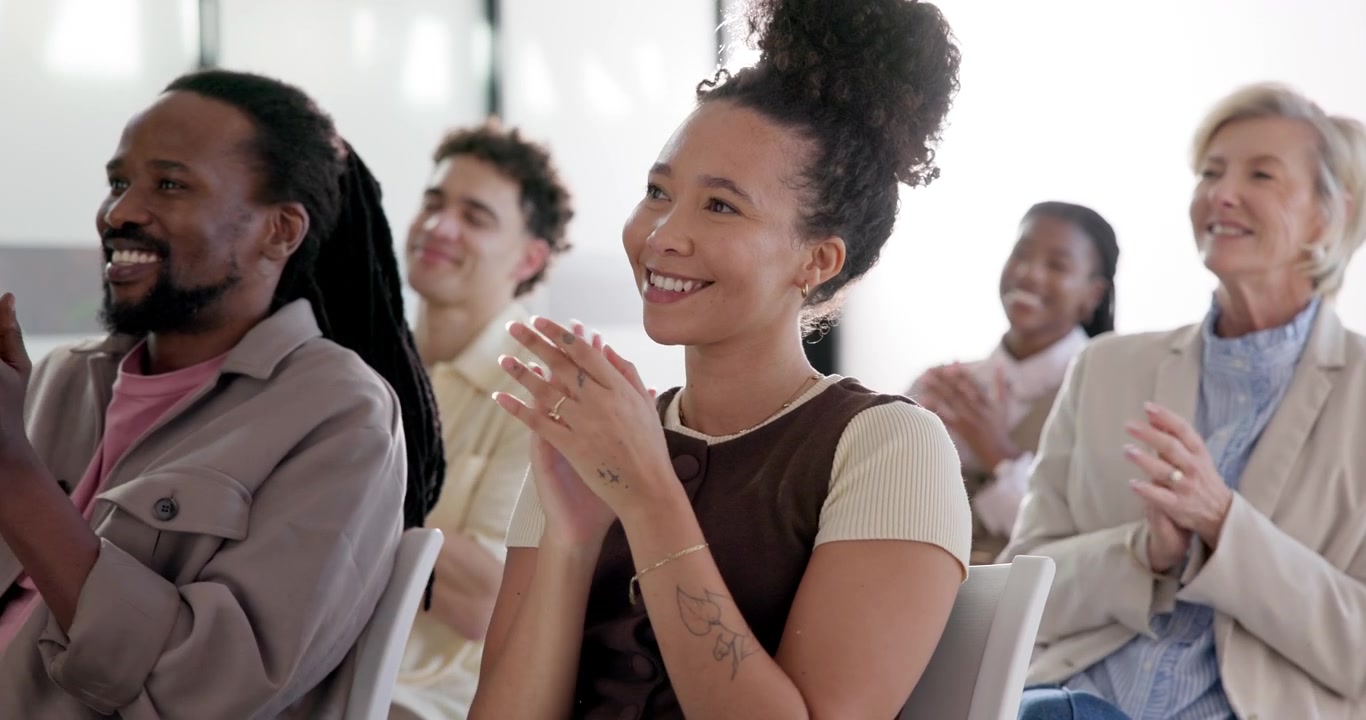 Diverse Group of Professionals Applauding During a Business Presentation