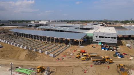 heavy machines constructing new customs terminal near gordie howe bridge, aerial view