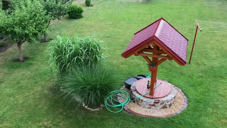 a stone water well in the garden in rainy weather