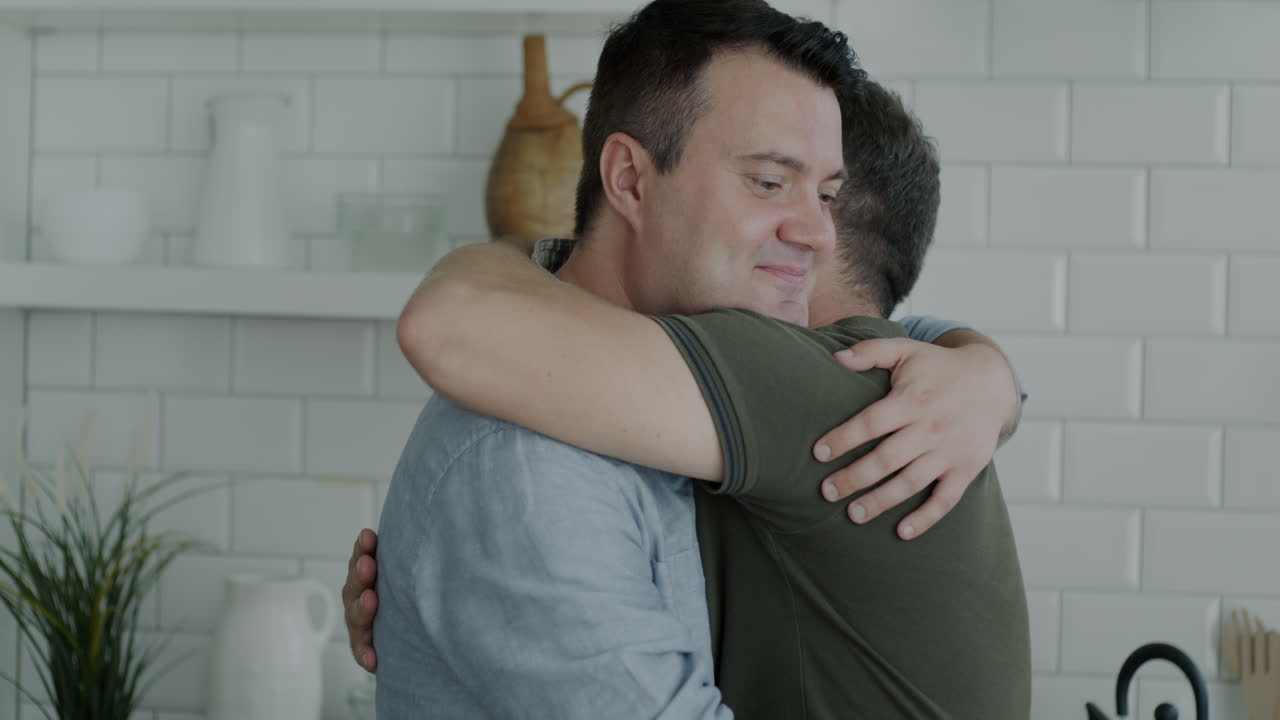 Two Men Hugging in a Kitchen