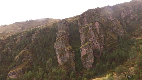 Aerial-establishing-shot-of-rocky-formations-on-a-cliff-face-in-the-jungle-in-Peru