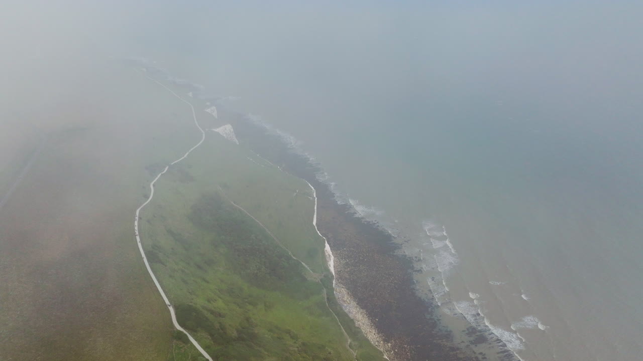 White Cliffs Of Dover Shrouded By Fog And Clouds In Kent, England, UK. - aerial shot