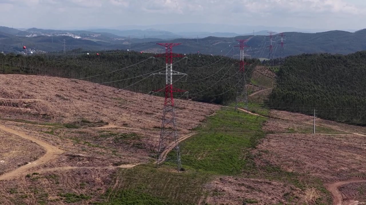 Aerial Drone Footage of High-Voltage Energy Transmission Towers Across Vast Landscape
