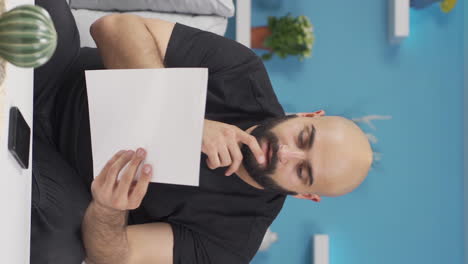 vídeo vertical del hombre que se regocija en el buen contenido del papeleo.