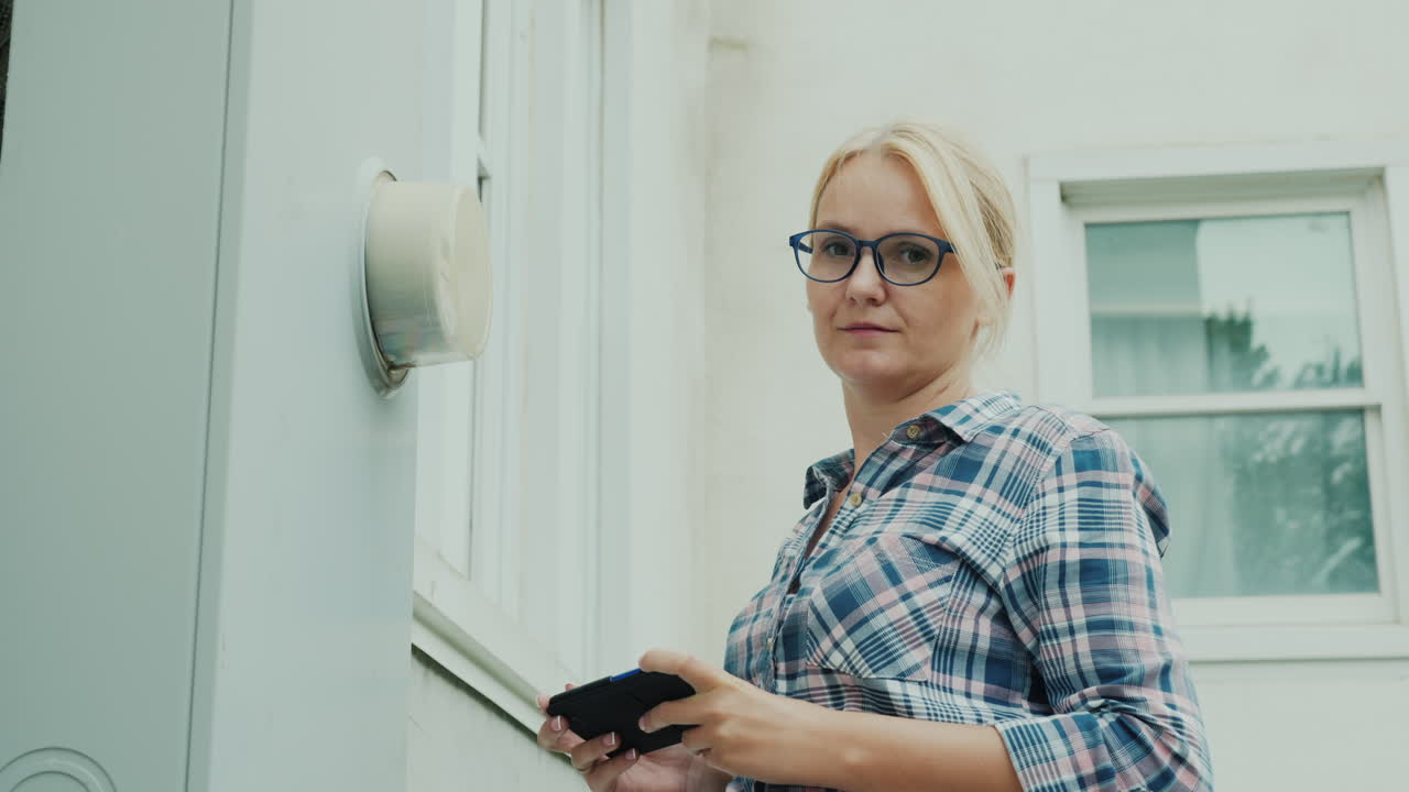 Woman Records Electricity Meter Readings Uses A Smartphone