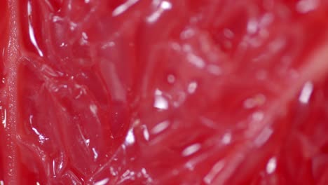 the pulp of ripe juicy red grapefruit. macro background.