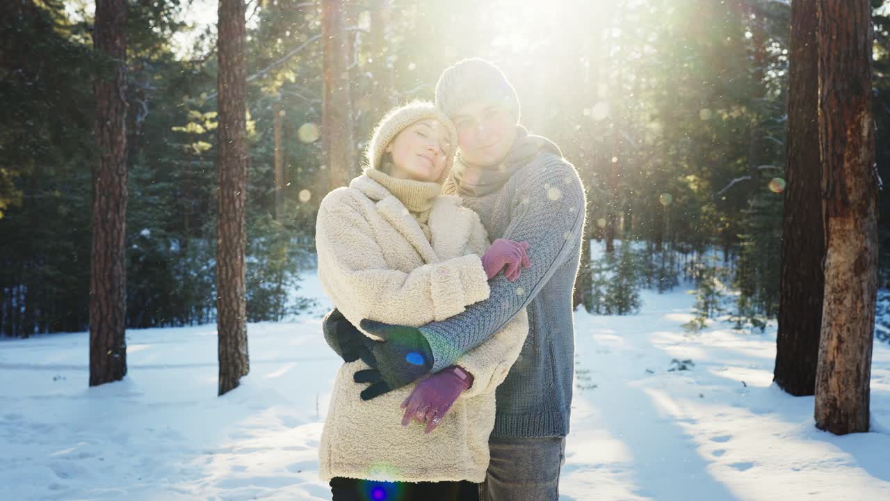 Couple in love embracing in a snowy forest