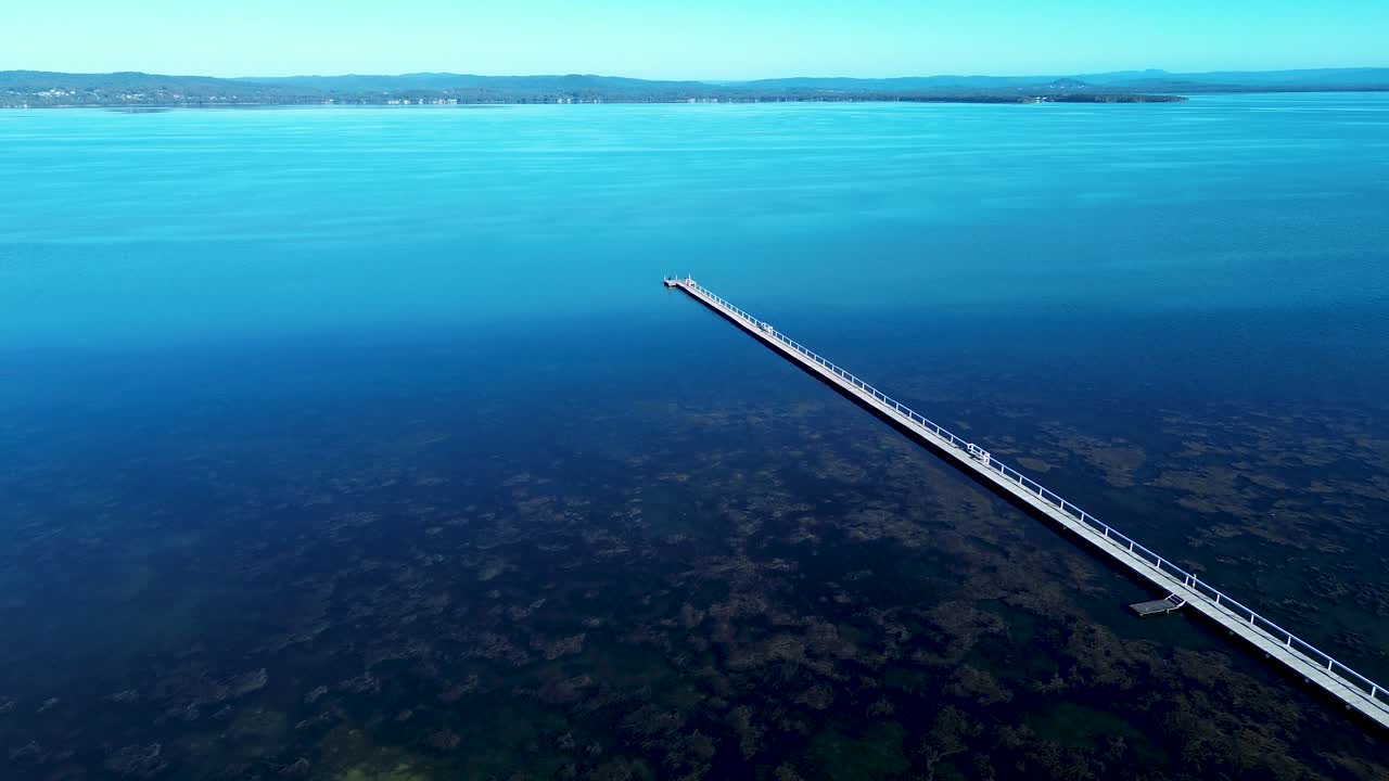 Drone aerial landscape of Long Jetty pier wooden boardwalk dock wharf in middle of Tuggerah lake river water catchment lagoon The Entrance Central Coast Australia fishing travel vacation holidays