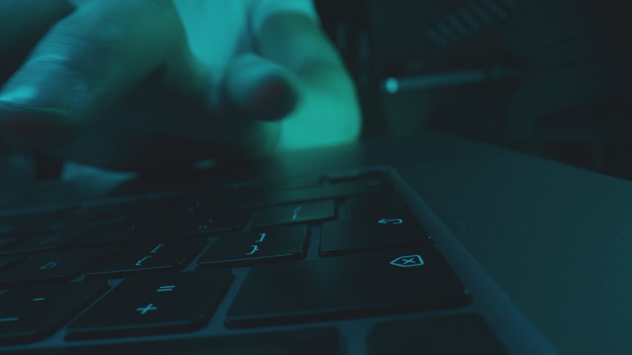 Person Typing on a Laptop Keyboard