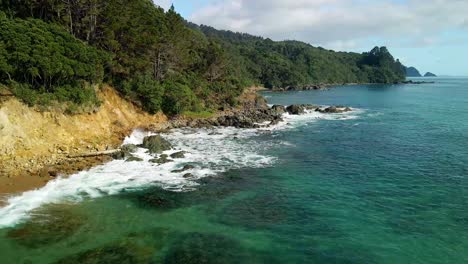 drone flying over secluded beach on new zealand's east coast