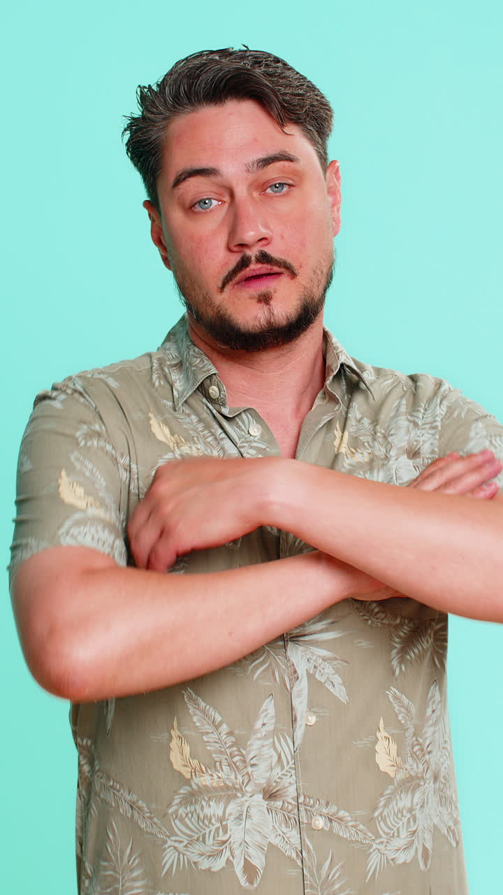 Man crossing arms on chest shaking head expressing disagreement refusal firm negative body language