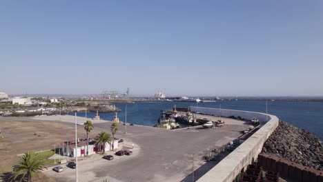 port of sines in portugal, aerial forward on a sunny summer day, blue sky