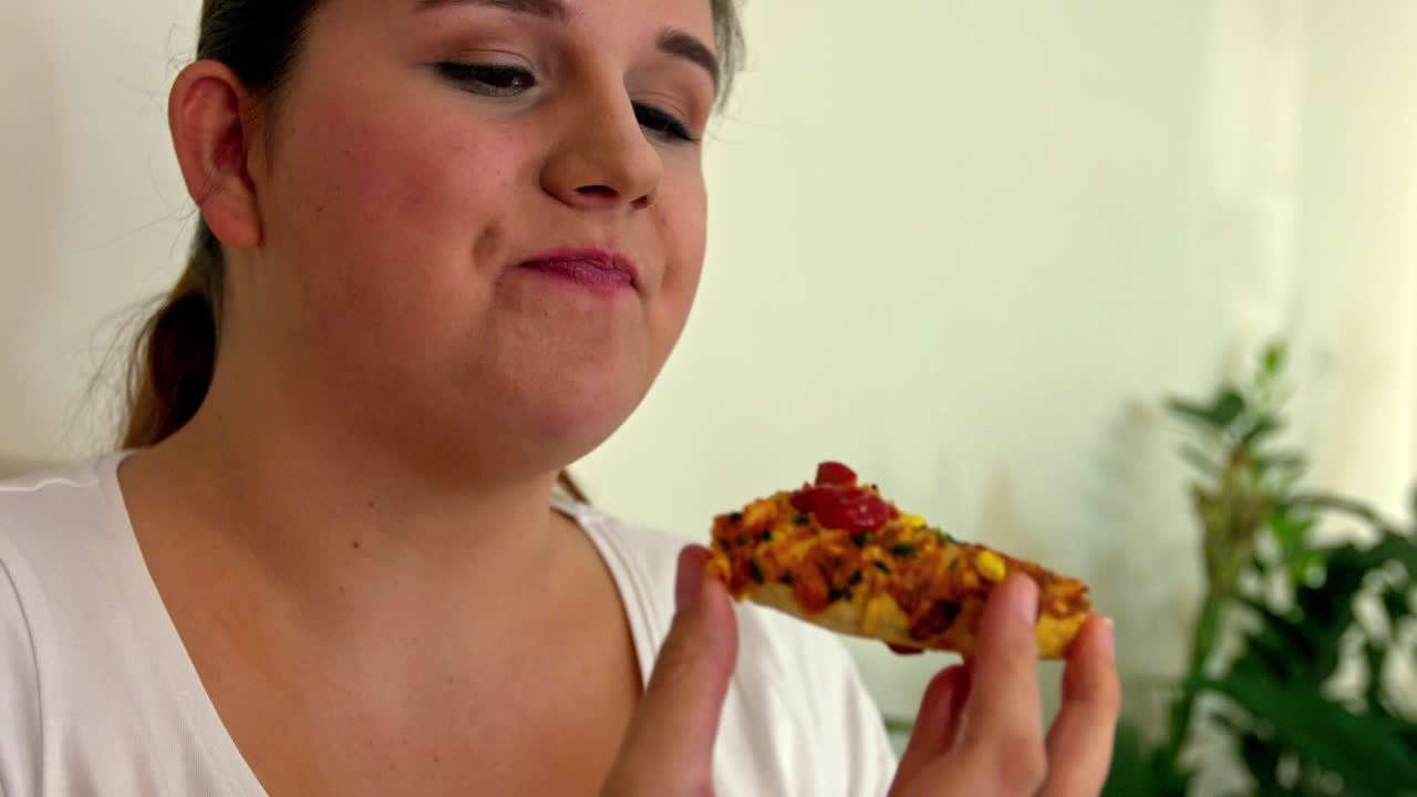 Overweight female person with junk dinner, obesity problem