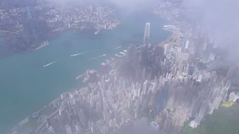 epic aerial view of the victoria harbour in a clear day, with thick cloud and sunlight