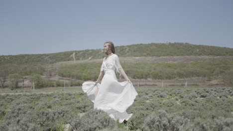 woman in white dress walking in a lavender field