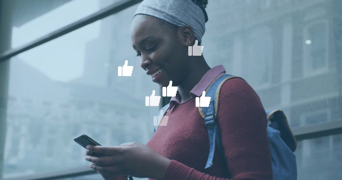 Student tapping phone at glass wall creating orbiting like icons indicating social media engagement