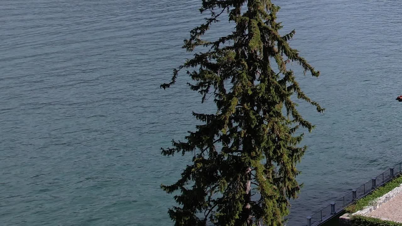 Drone captures serene view of the Alps near a tranquil lake in Italy