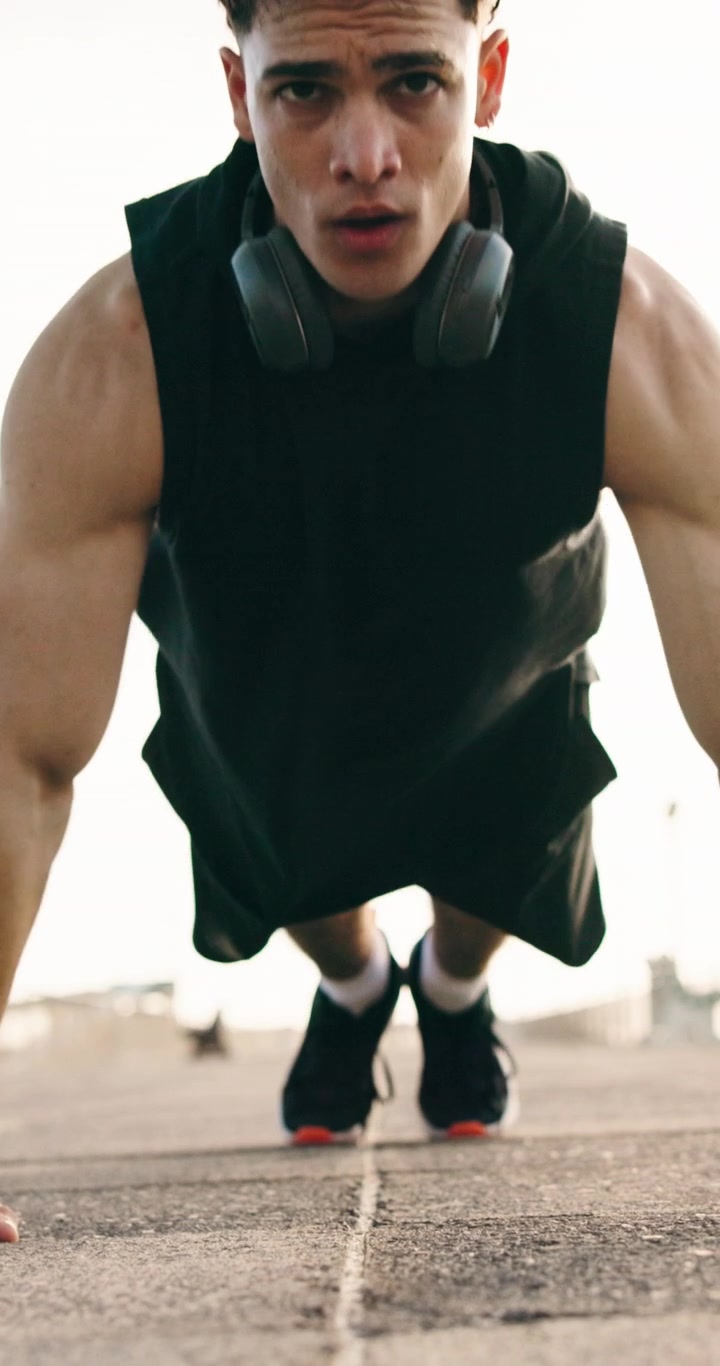 Young Man Doing Pushups Outdoors During Workout