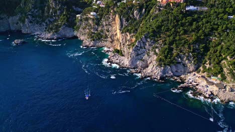 Sea-Cliffs-Of-The-Touristic-Island-Of-Capri-In-Italy---aerial-shot