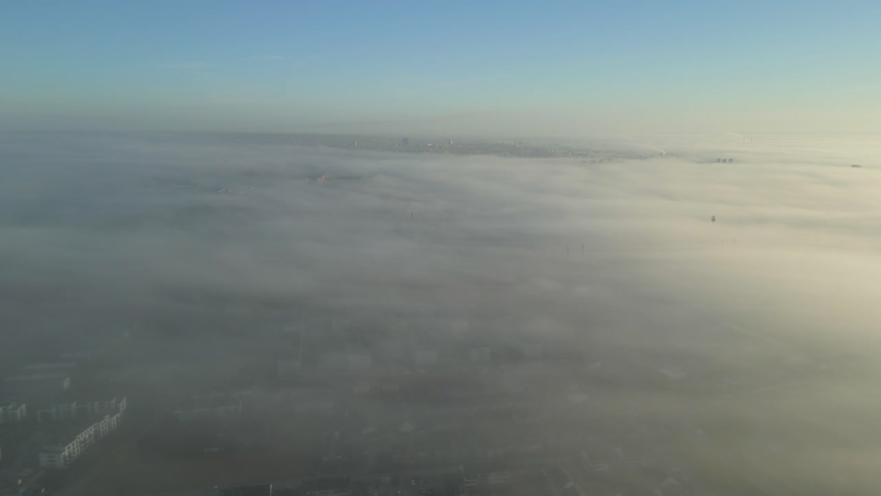 Aerial View of City Covered in Fog at Sunrise