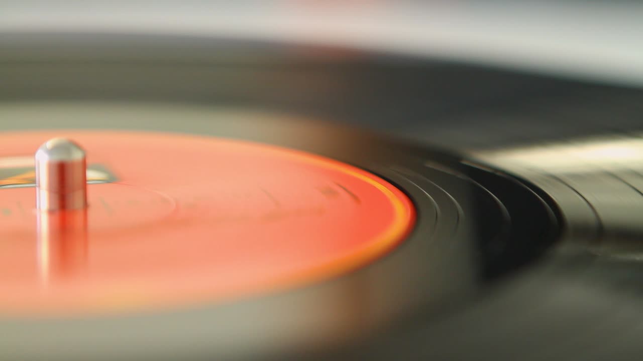 Close-up of a spinning vinyl record creating a nostalgic and vintage ambiance