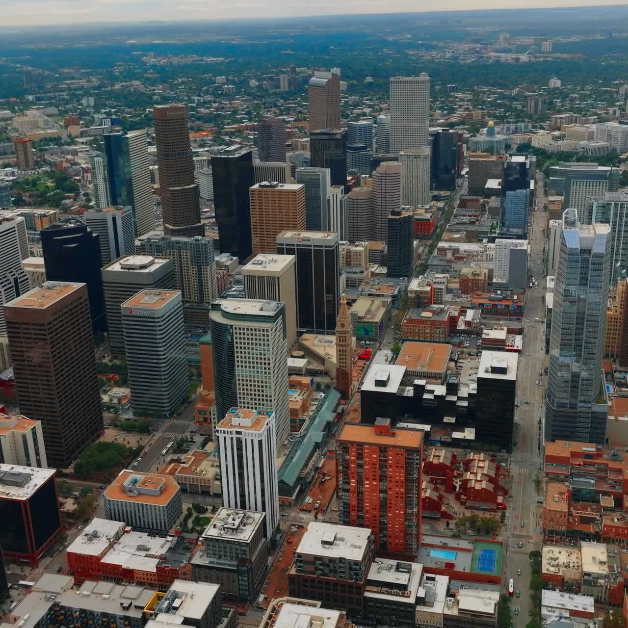 Gorgeous view of skyscrapers in the downtown of beautiful Denver, Colorado, USA. Metropolis centre at backdrop of green city at daytime from bird's eye view