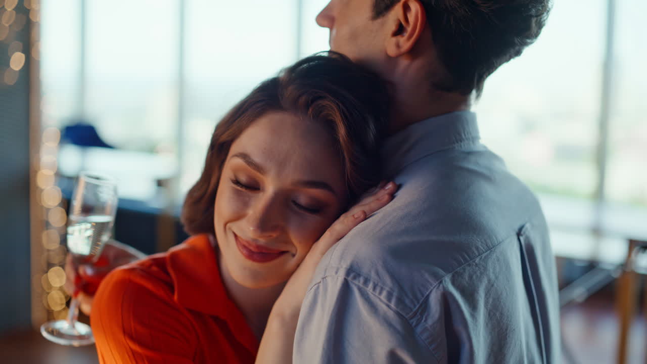 Tipsy couple dancing sensually at cozy panoramic room closeup. Affectionate pair