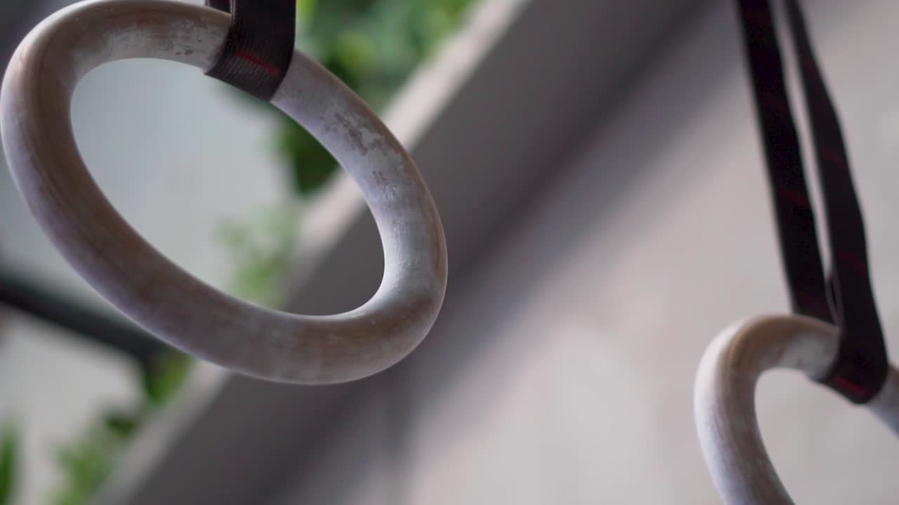 slow pan around hanging pull up hoops in gym