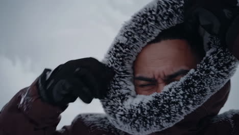 man in a frozen hood in winter