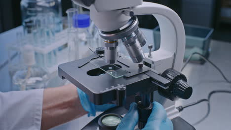 scientist using a microscope in a laboratory setting